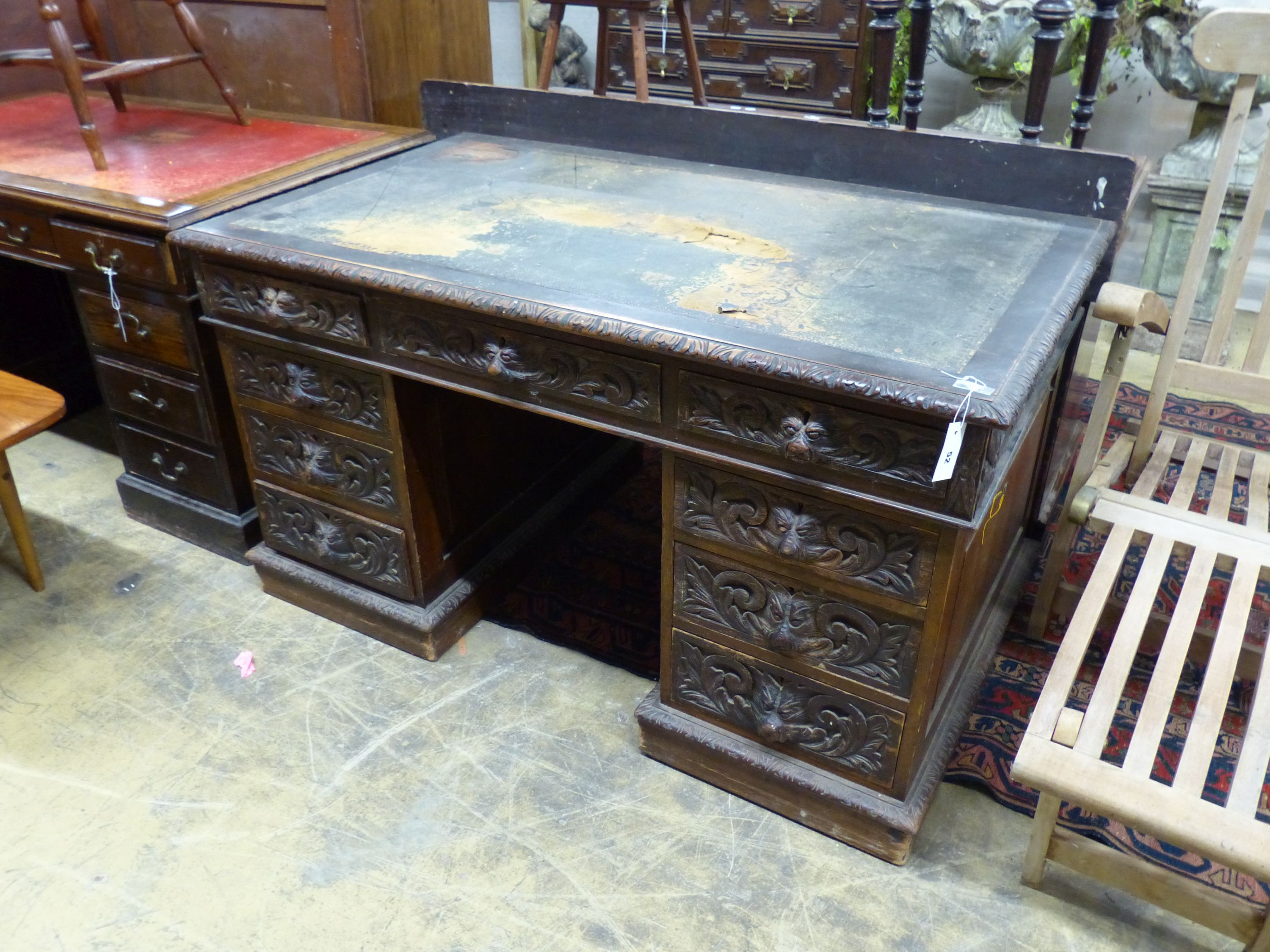 A late Victorian carved oak pedestal desk, length 138cm